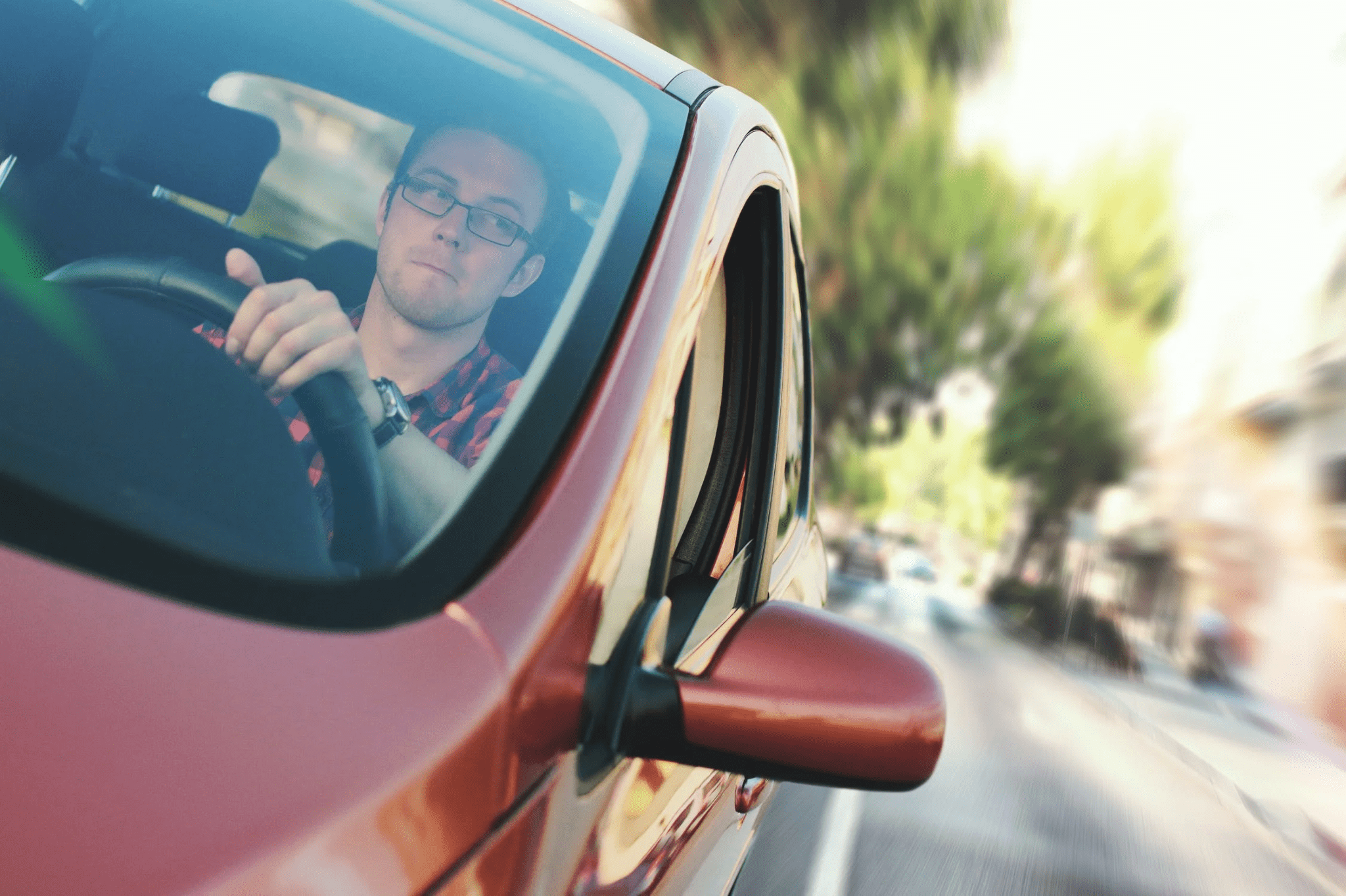 Young man driving car carefully
