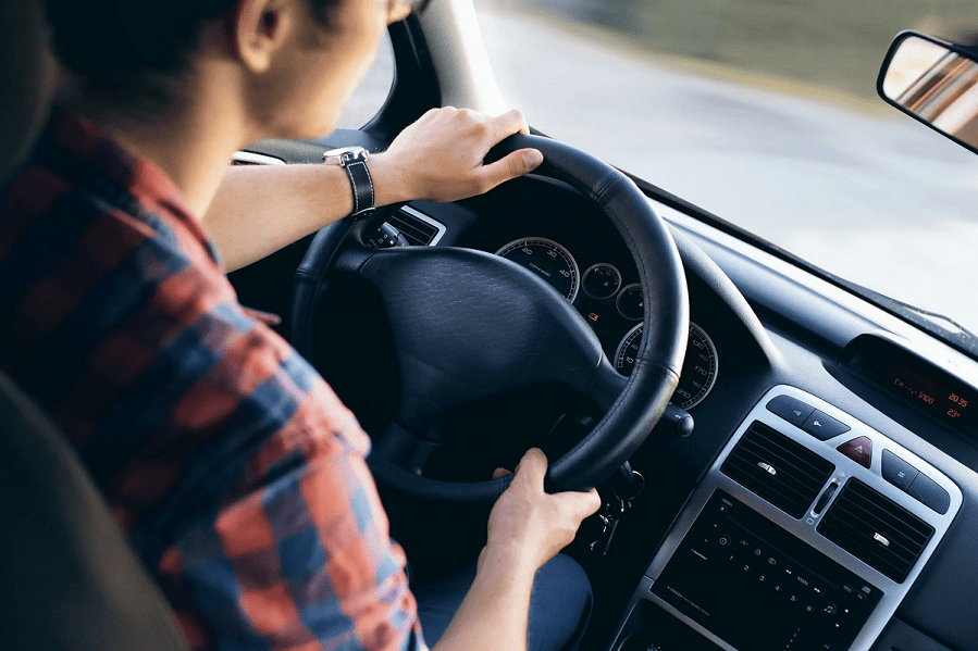Young driver in a modern car in motion