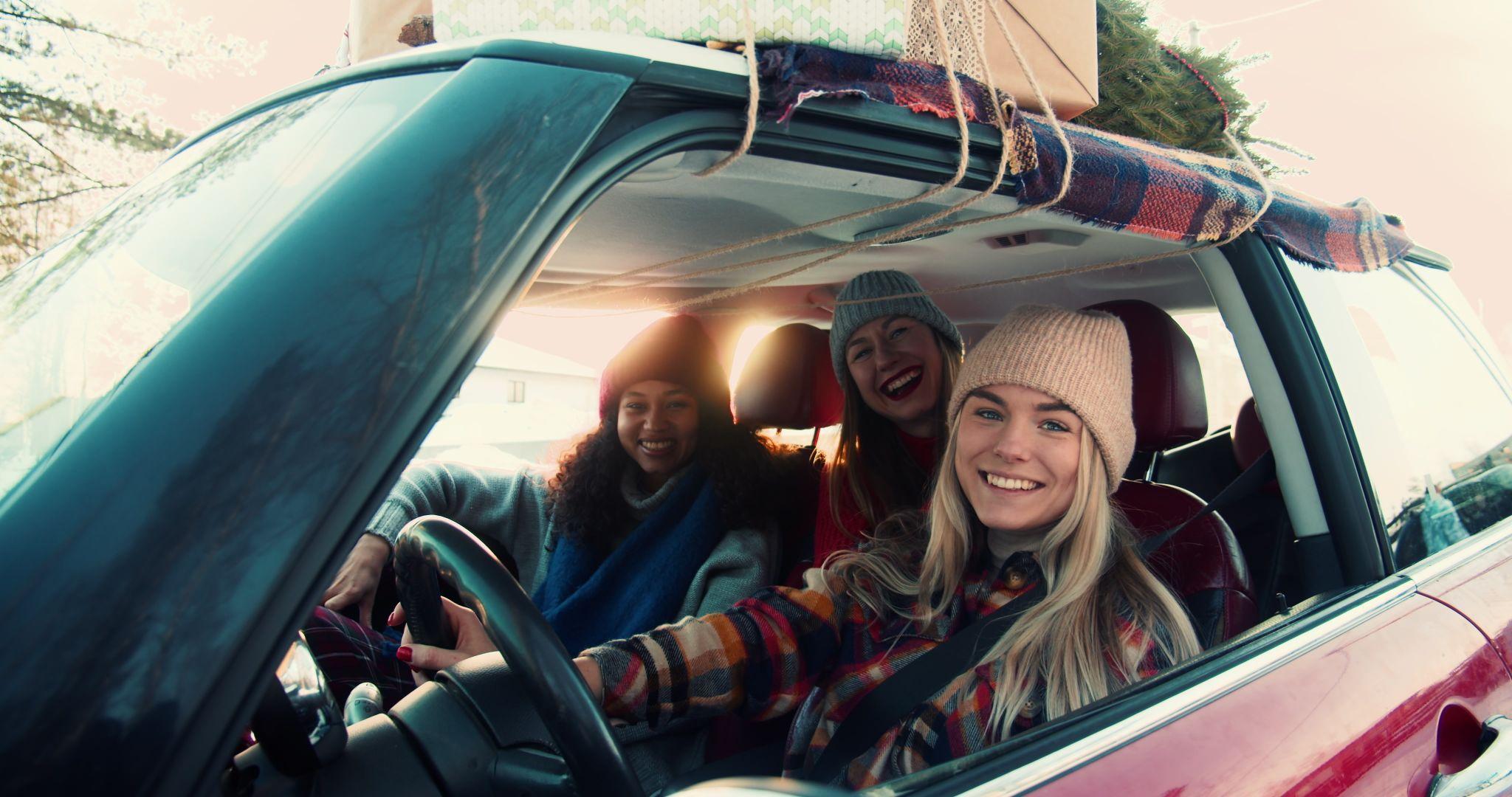 Three happy young excited multiethnic women posing, smiling at camera