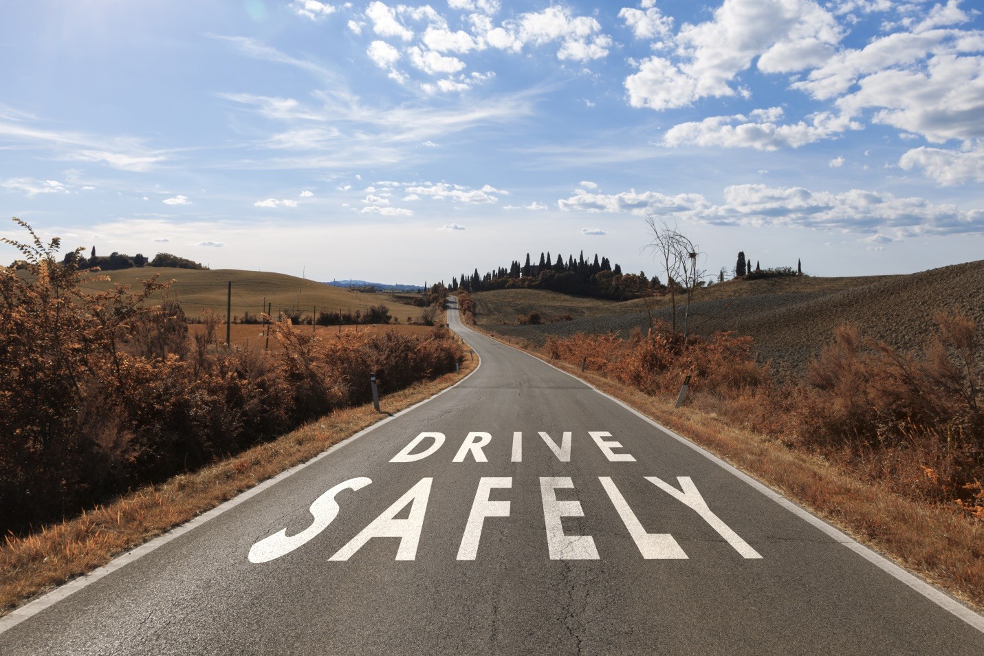drive safely message on the sunny summer asphalt country road