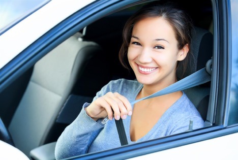 women putting on seatbelt