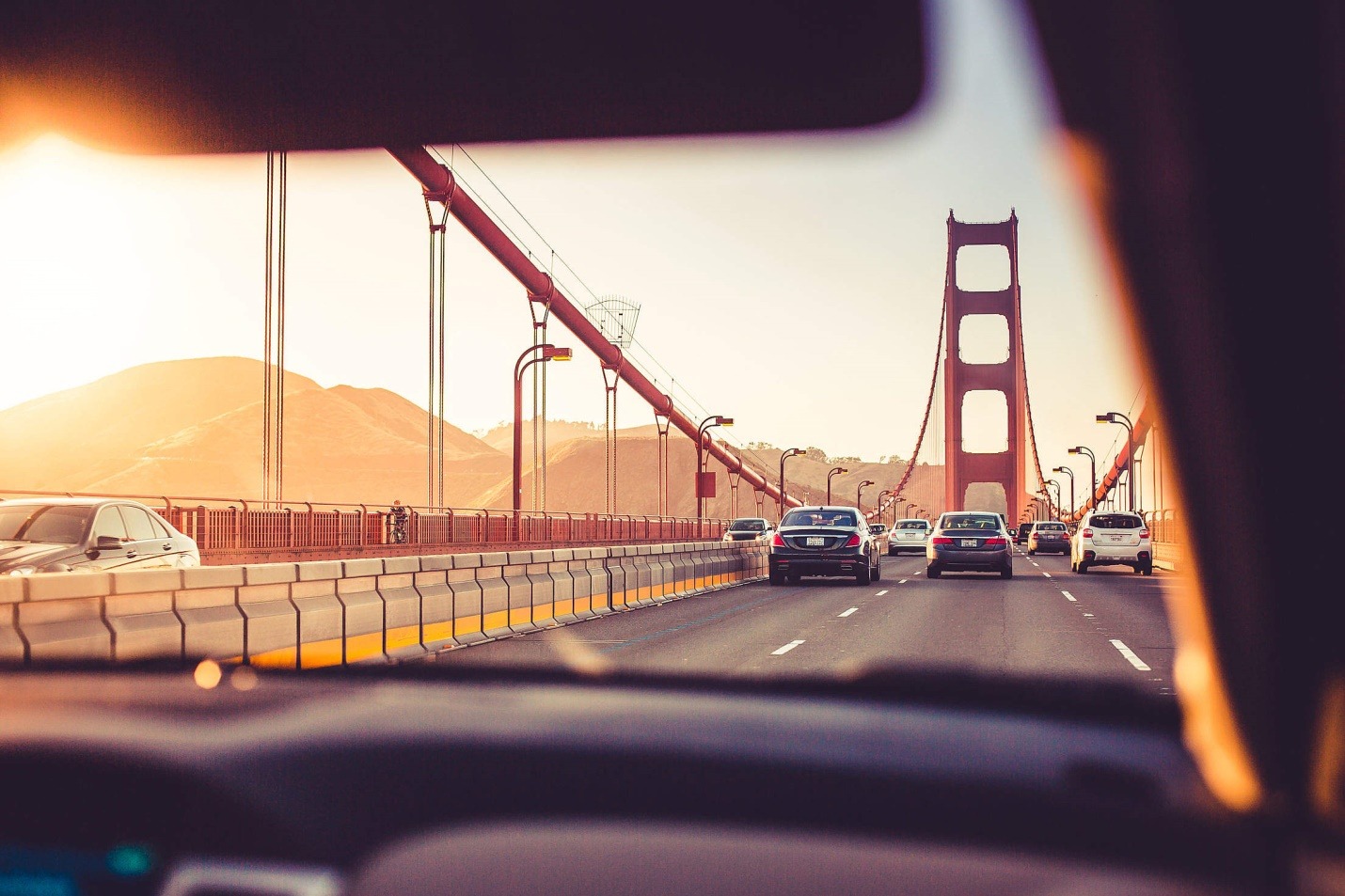 driving over the golden gate bridge in sunset
