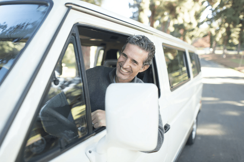 man leaning on van window
