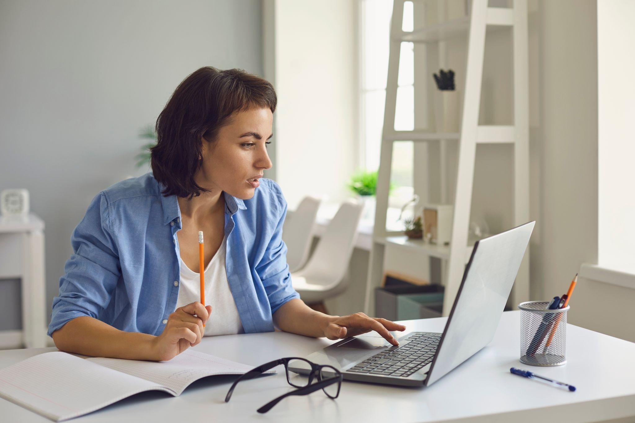 woman sitting with laptop going through online drivers ed course