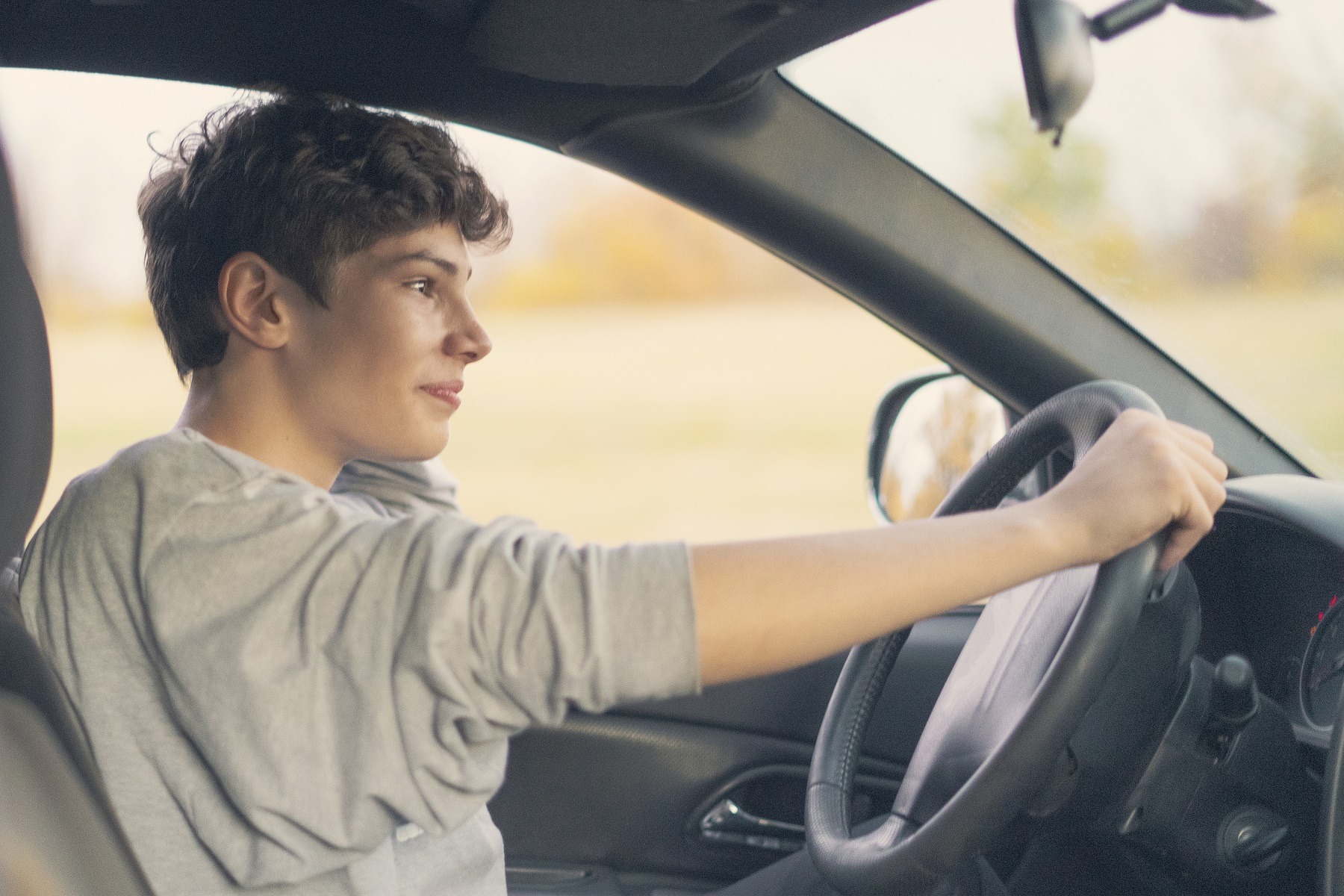 young teenager learns how to drive the car