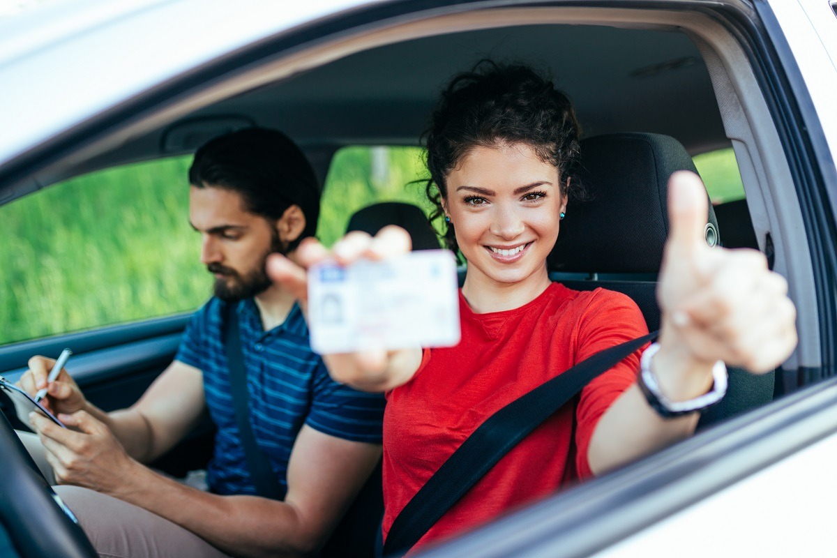 Beautiful young woman successfully passed driving school test