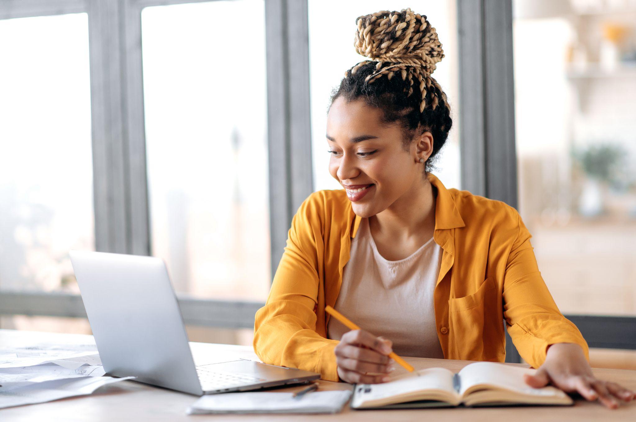 e-learning. Happy african american young woman studying remotely