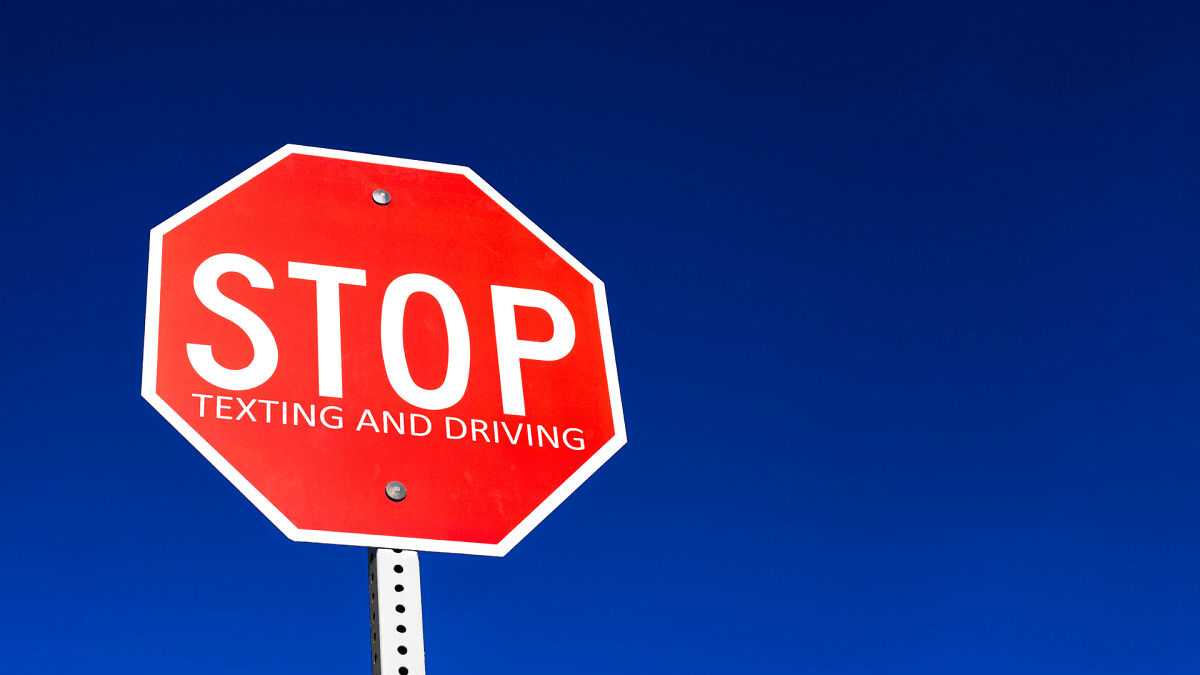 Stop traffic sign against blue sky.