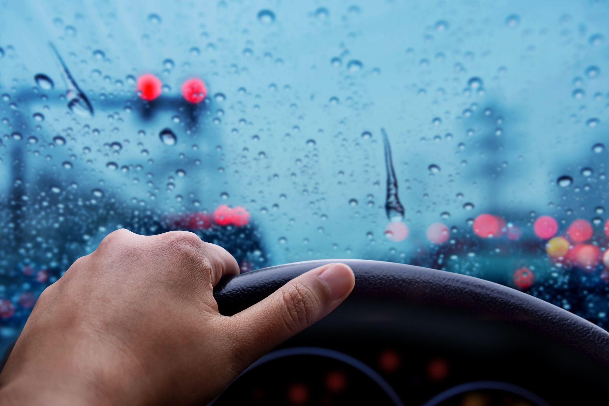 Bad weather on the road with blurred lights and traffic jam in city