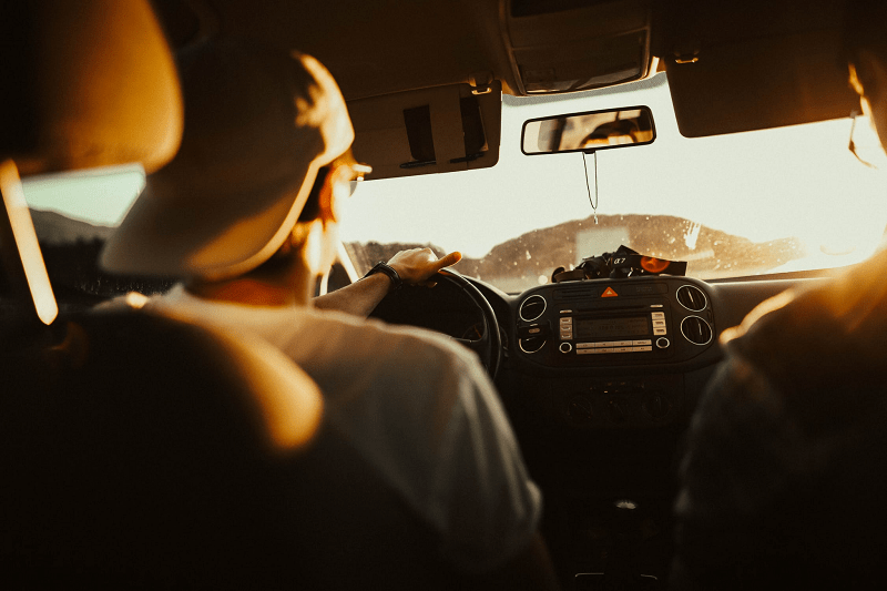 Man driving a car with a friend