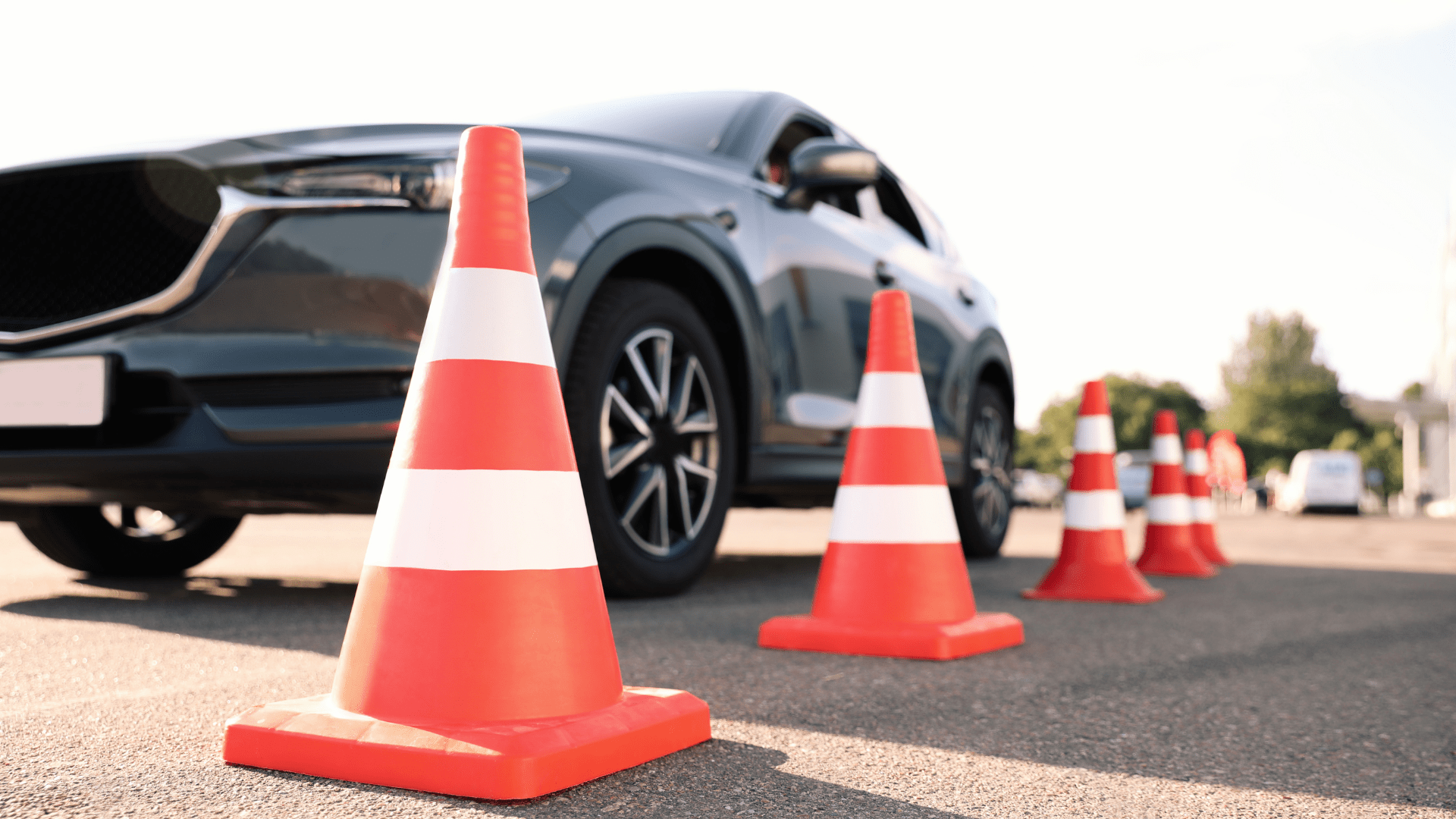 Traffic cones near car outdoors. Driving school exam