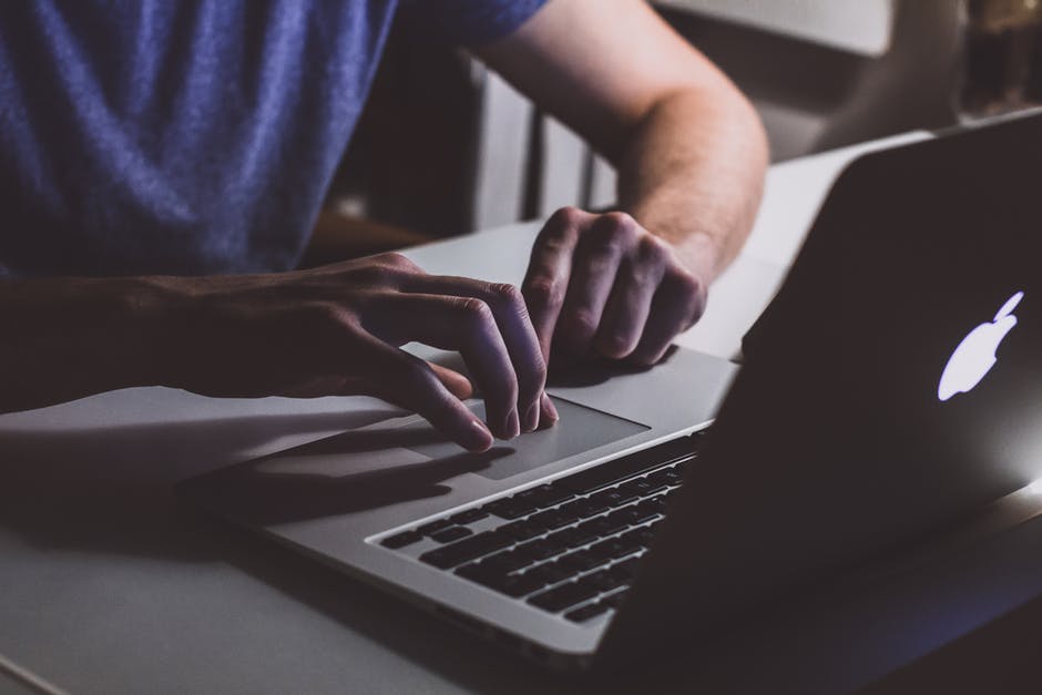 man working on his macbook