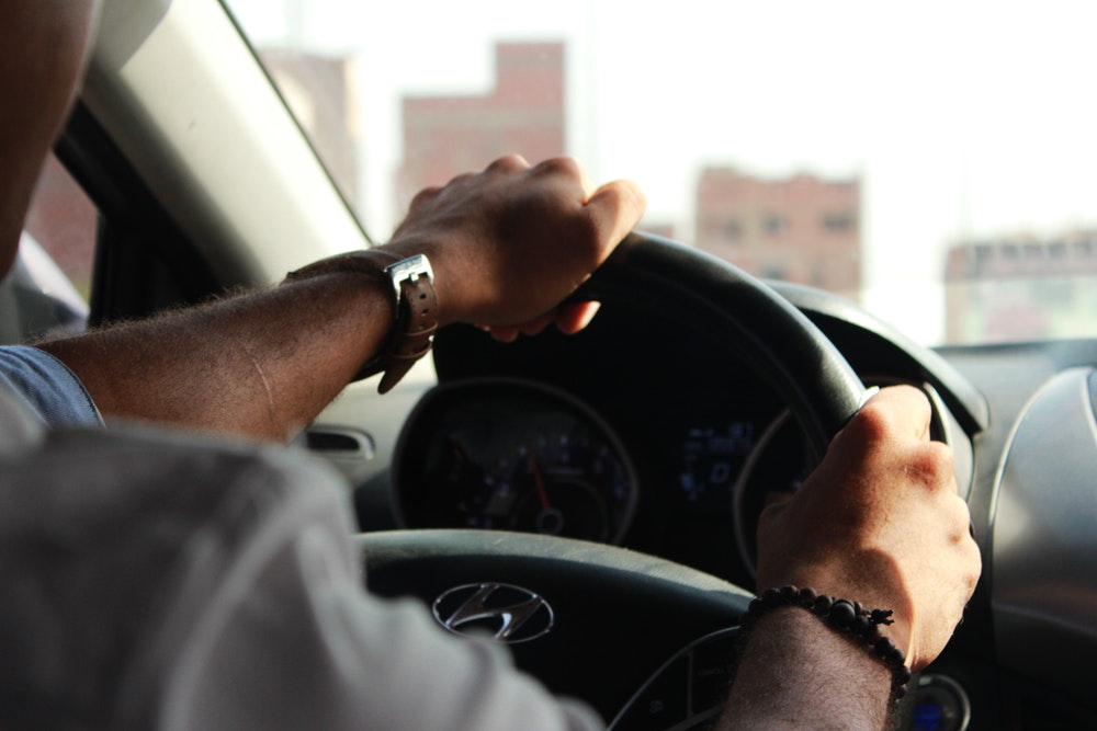 person holding steering wheel