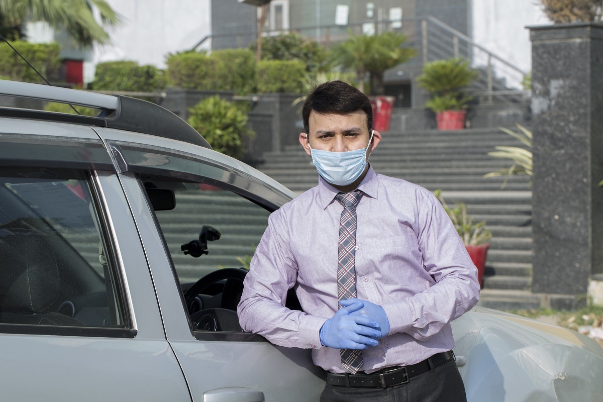 Man holding hands crossed and wearing hygienic mask