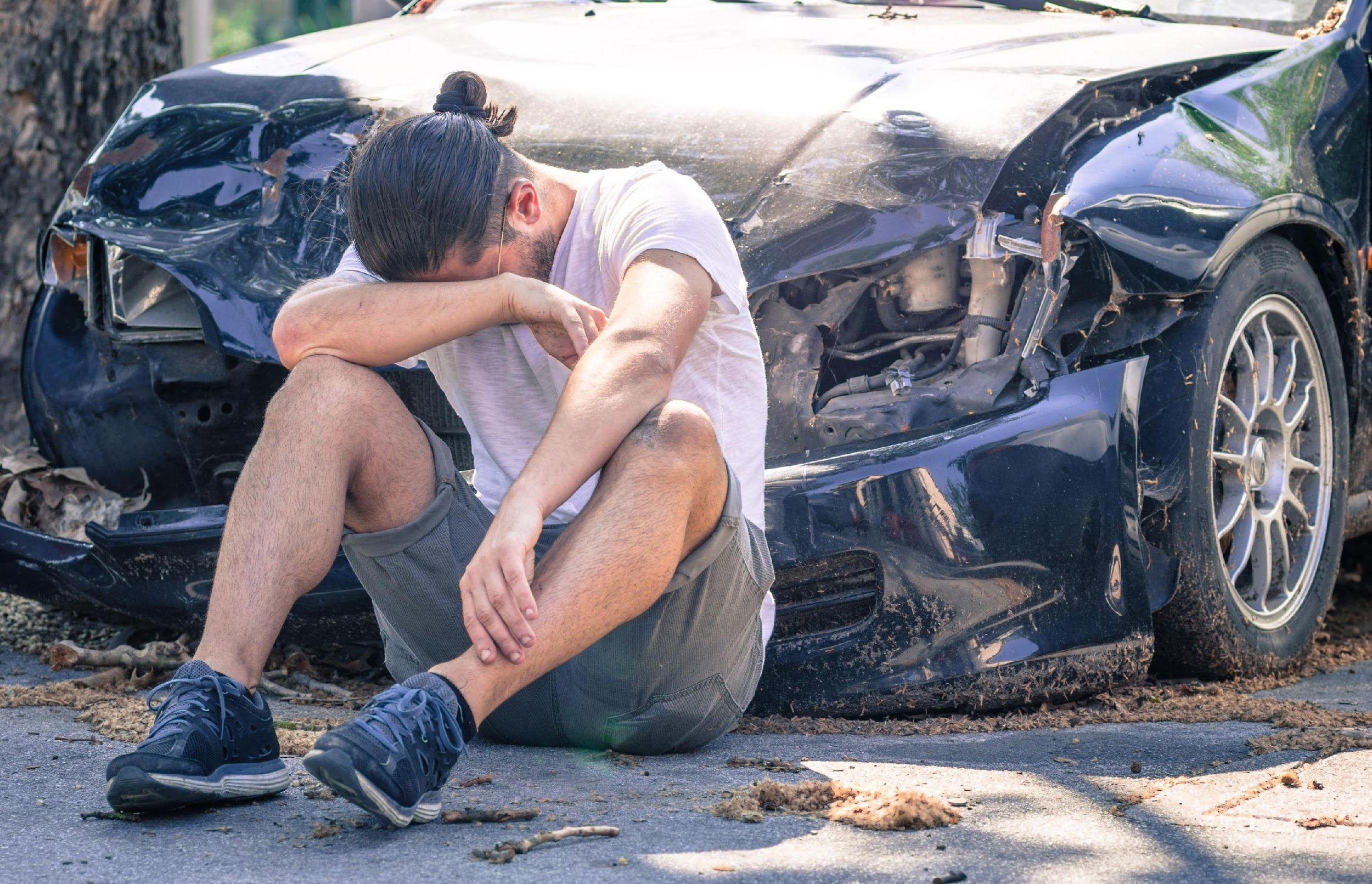 Sad man crying after car crash