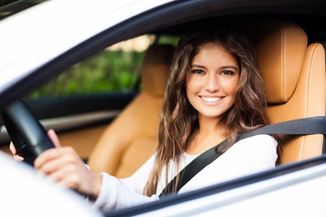 women smiling in a white car