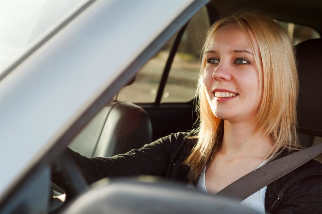young teenage girl driving a car