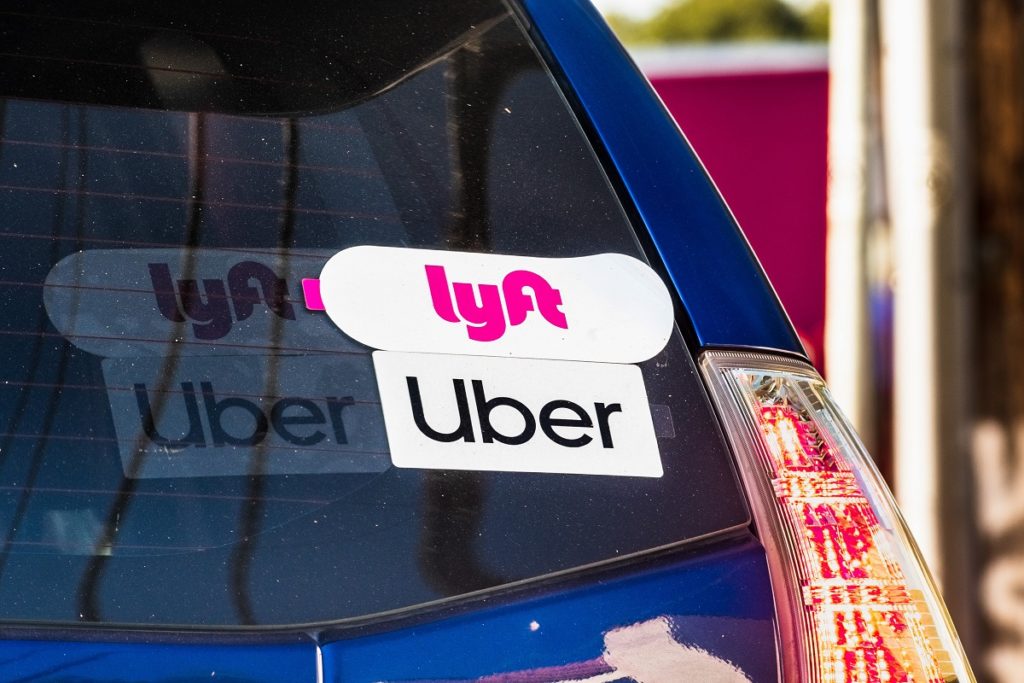 Lyft and UBER stickers on the rear window of a vehicle Ticket School