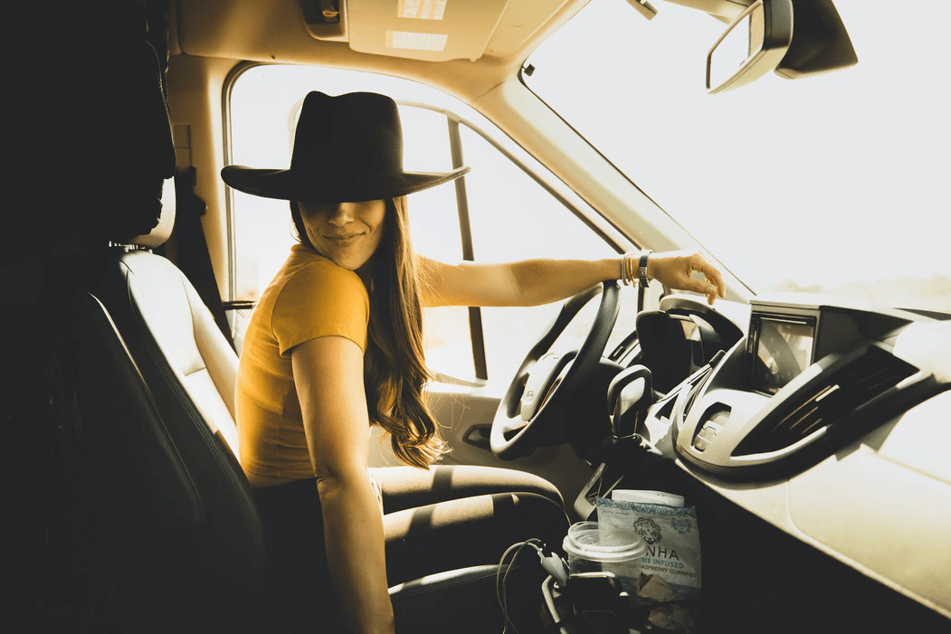 Attractive young woman is sitting car