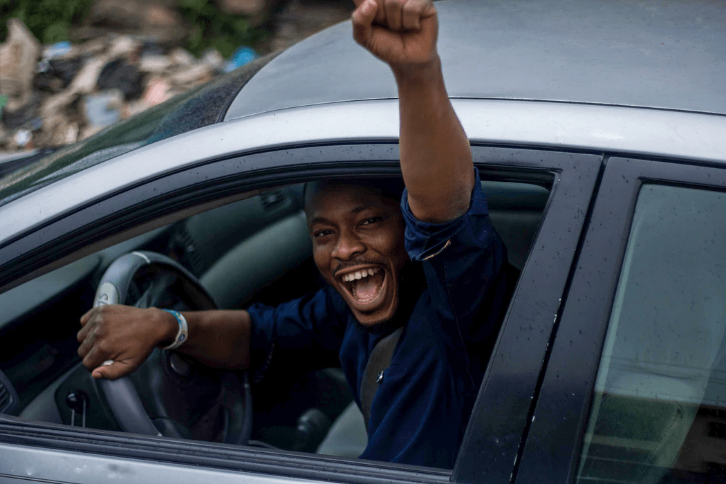 Happy man sitting on car seat