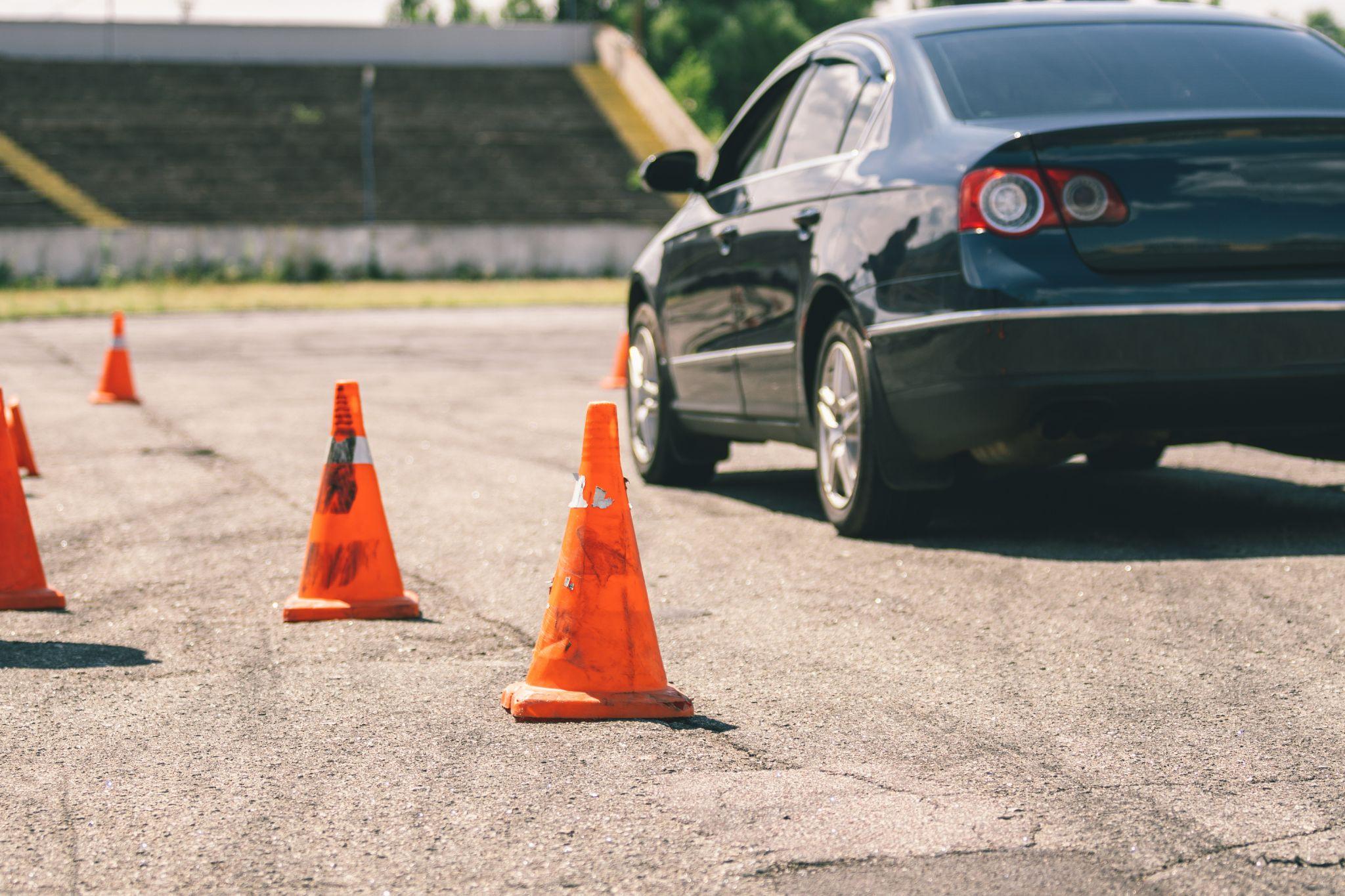 Car and traffic cones, driving school concept.