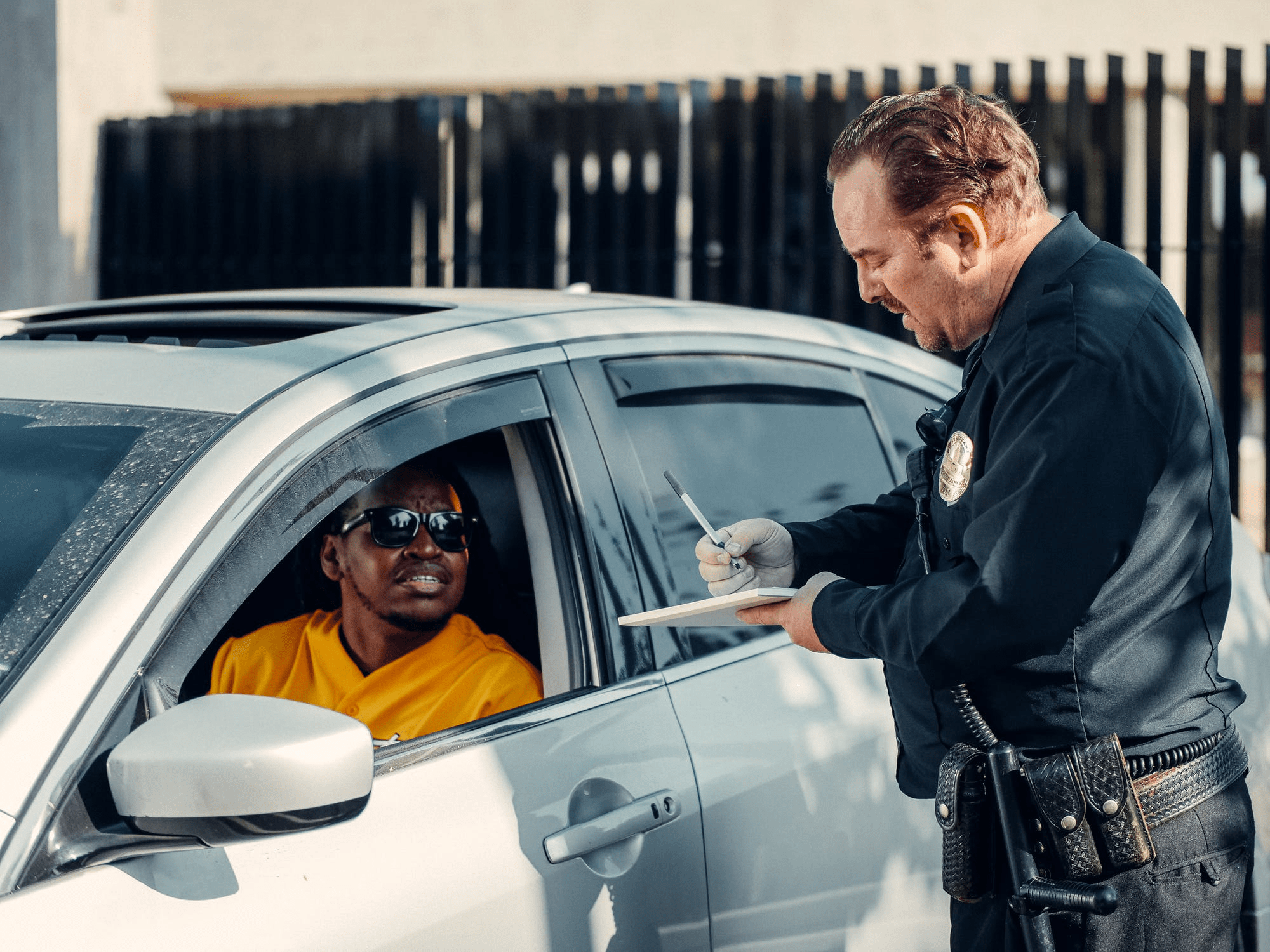Policeman in uniform writes fine to male driver