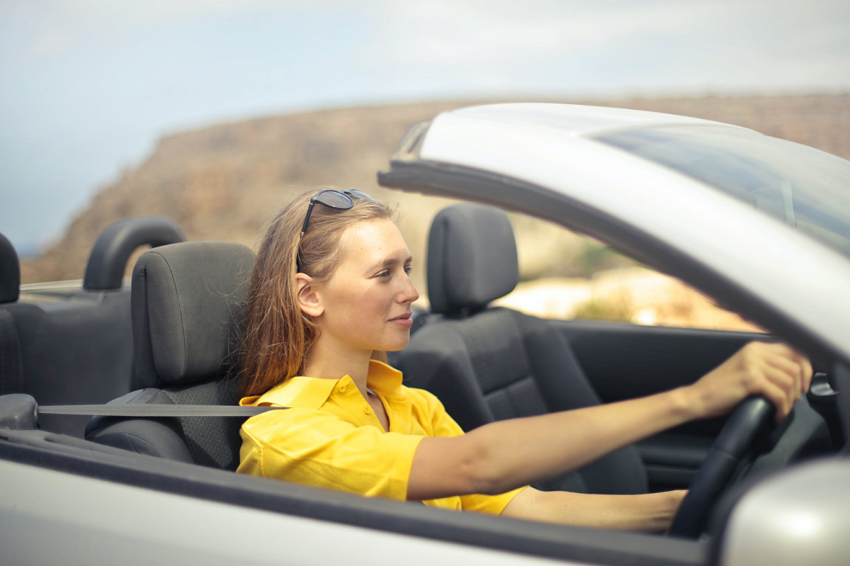 Smiling woman driving a sporty car