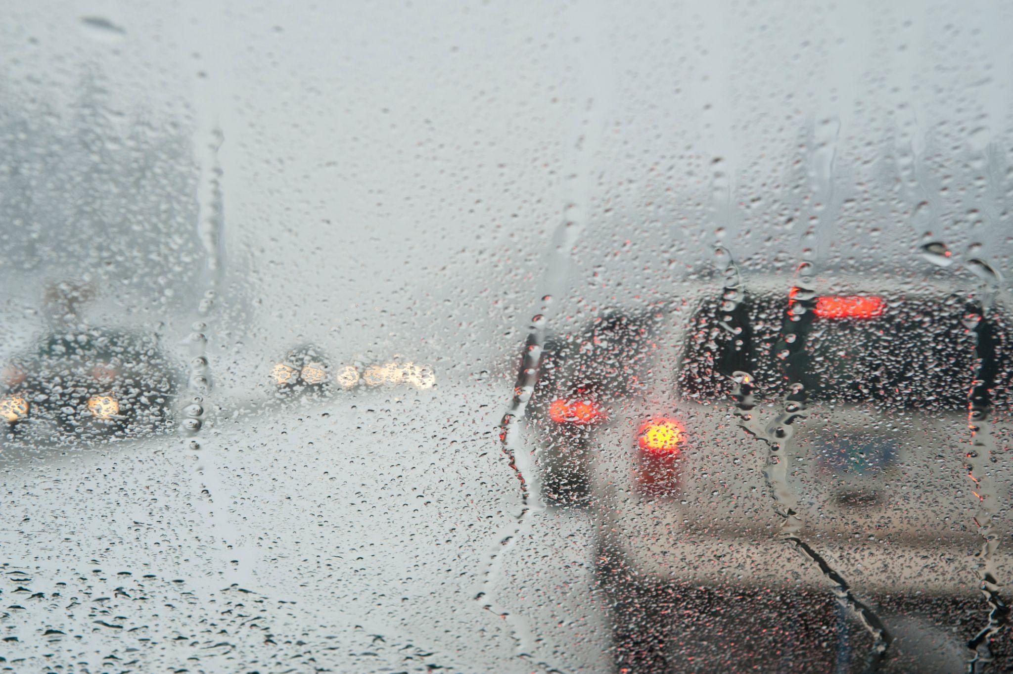 cars in traffic during heavy rain and snow