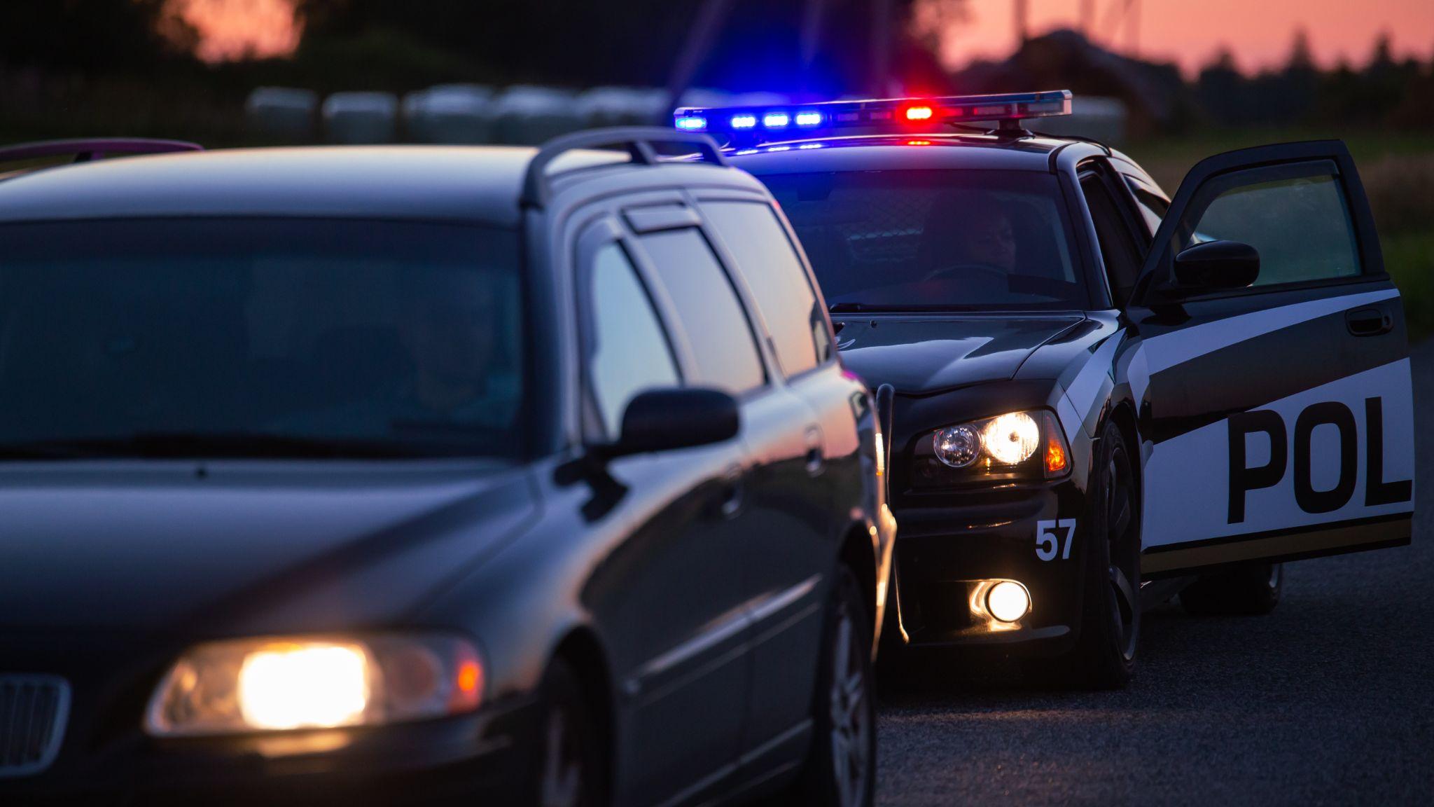 Highway traffic patrol car pulls over vehicle on the road